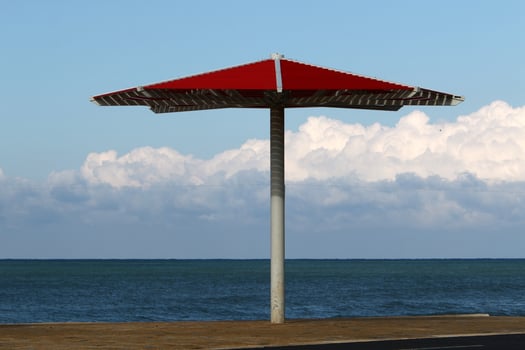 Umbrella in the city park near the sea. photo