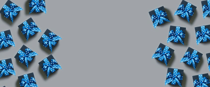 Banner with Black gift boxes with bow flat lay on grey background. View from above. Copy space photo