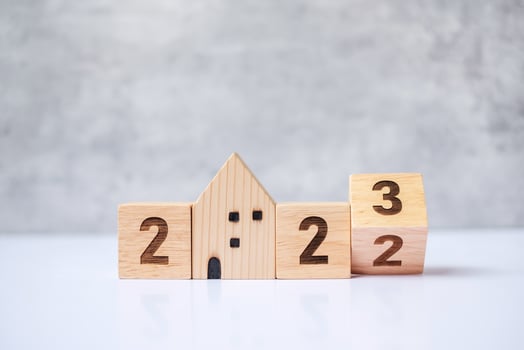 flip 2022 to 2023 block with house model. real estate, Home loan, tax, investment, financial, savings and New Year Resolution concepts photo