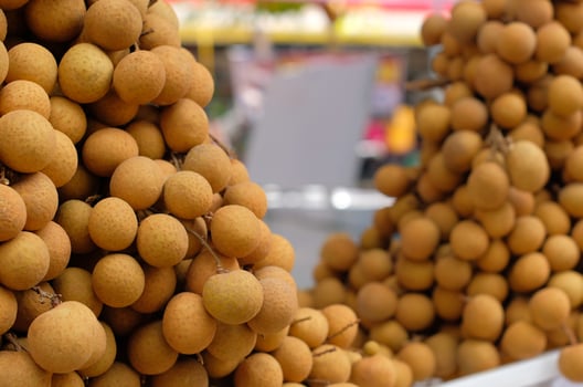 Fresh longan fruit on the market. close up details of longan fruit or kelengkeng fruit. photo