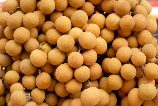 Fresh longan fruit on the market. close up details of longan fruit or kelengkeng fruit. photo