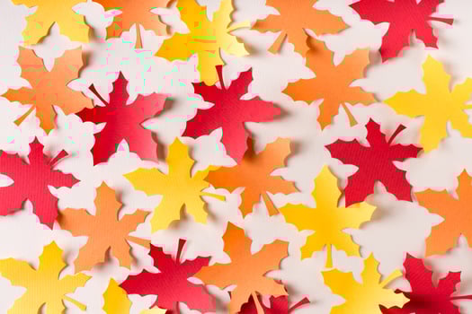 Beautiful background of cut maple leaves from craft paper. Autumn decoration. photo