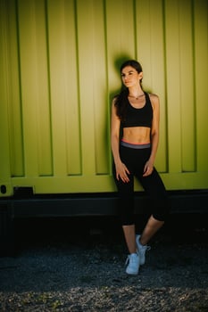 Pretty young woman  taking a break during exercising outside photo