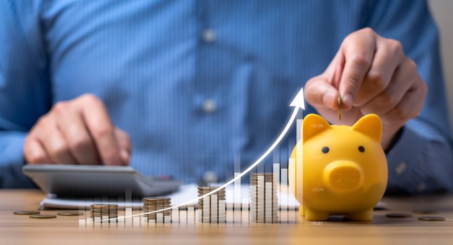 Interest rate and dividend concept. Businessman keeps his money in a piggy bank and shows positive returns with a virtual holographic arrow chart. income, return, retirement, investment, save money photo