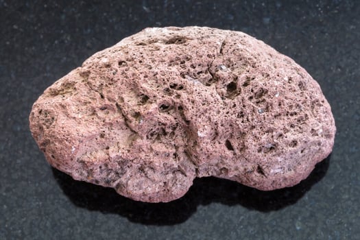 red pumice stone on dark background photo