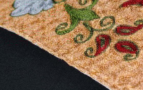 A closeup shot of national ornaments and patterns of Central Asia on a piece of fabric photo