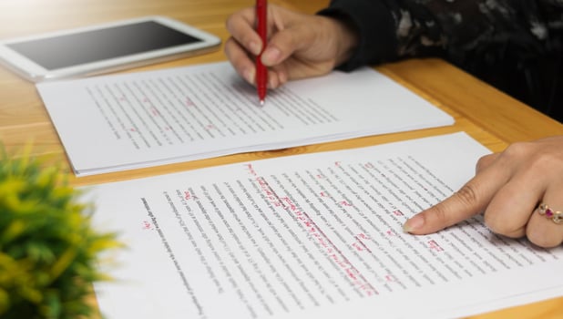 proofreading paper on table photo