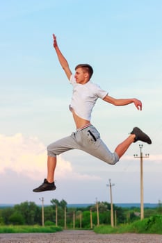 happy young man jumping in up on nature photo