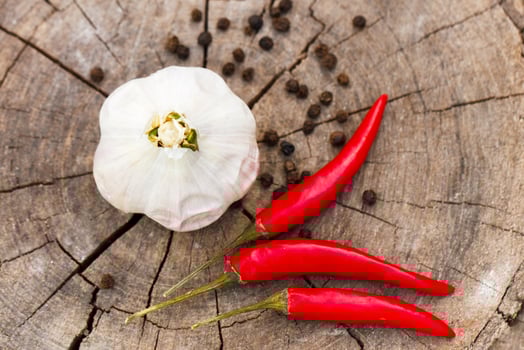 garlic and pepper on a wooden background close-up photo