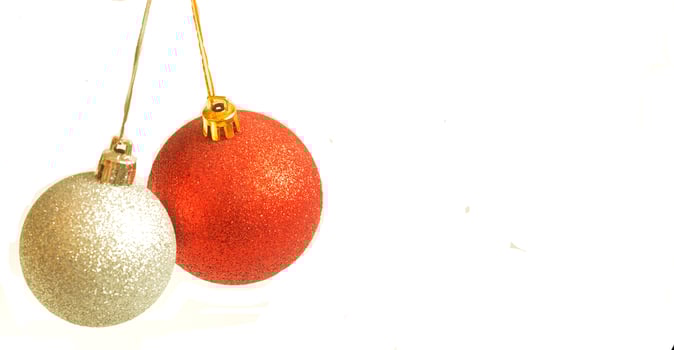 Red and silver christmas ball hanging on ribbon on white background photo