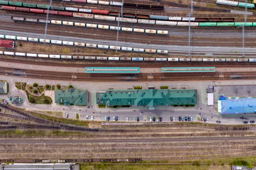 aerial view over long railway freight trains with lots of wagons stand on parking photo