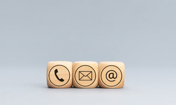 Contact icons on wooden blocks on gray background. Copy space photo