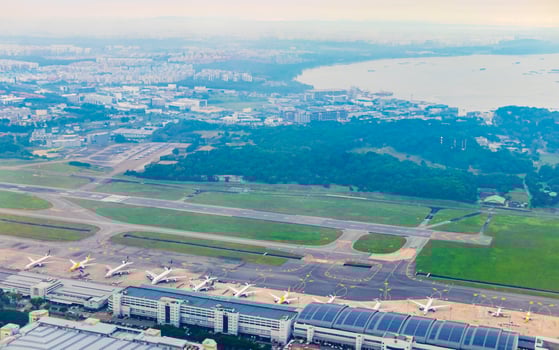 Flying above the clouds and the landscape airport over Singapore. photo