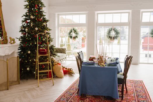 Christmas decor in the living room with large windows, dining table and Christmas tree photo