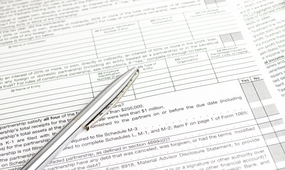 pen, calculator and tax forms concept on white background photo