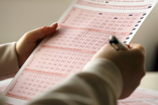 Filling out a lottery ticket. A young woman plays the lottery and dreams of winning the jackpot photo