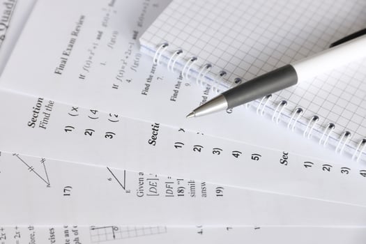 Handwriting of mathematics quadratic equation on examination, practice, quiz or test in maths class. Solving exponential equations concept. photo