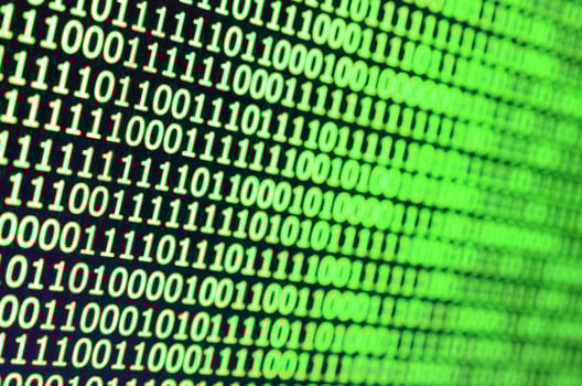 Macro shot of binary code on the monitor of an office computer. The concept of the programmer's work. The flow of digital information strings photo
