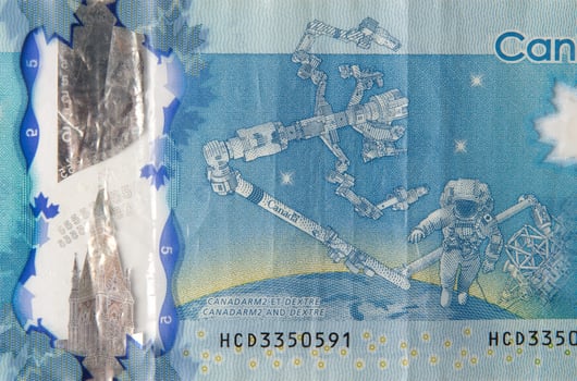 Dextre and canadarm2 on Canada 5 Dollars 2013 Polymer Banknote fragment photo