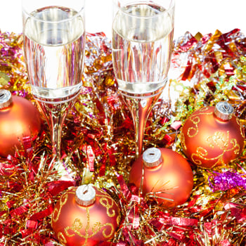 glasses with orange Xmas decorations on white photo