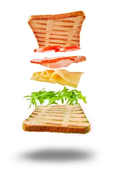 Flying sandwich with ingredients on wite background photo