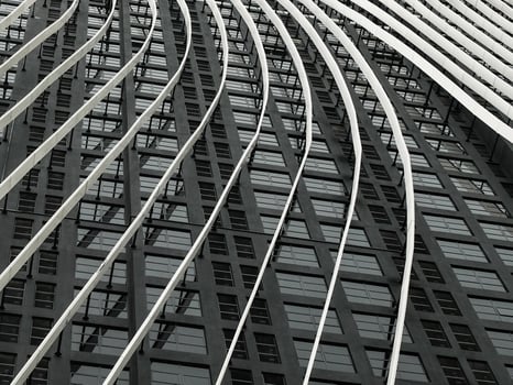 White and curved steel pattern line up a black building exterior photo