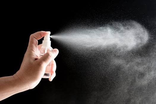 Hand a man Press the alcohol spray bottle for protection and quarantine pandemic virus, cleaning concept in dark background photo