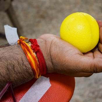 Blood donor at Blood donation camp held with a bouncy ball holding in hand at Balaji Temple, Vivek Vihar, Delhi, India, Image for World blood donor day on June 14 every year, Blood Donation Camp photo