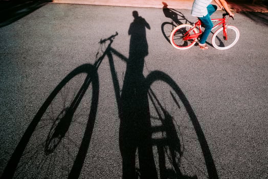 Personal point of view of a cyclist riding past by in the evening photo