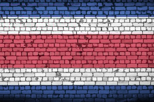Costa Rica flag is painted onto an old brick wall photo