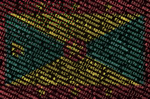 Grenada flag  is depicted on the screen with the program code. The concept of modern technology and site development photo