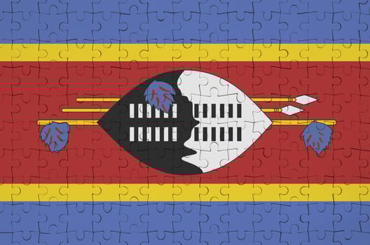 Swaziland flag  is depicted on a folded puzzle photo