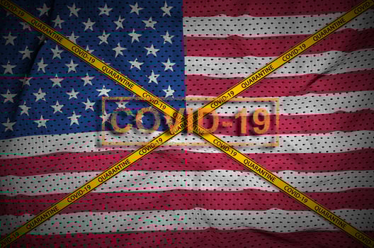 United States of America flag and Covid-19 stamp with orange quarantine border tape cross. Coronavirus or 2019-nCov virus concept photo