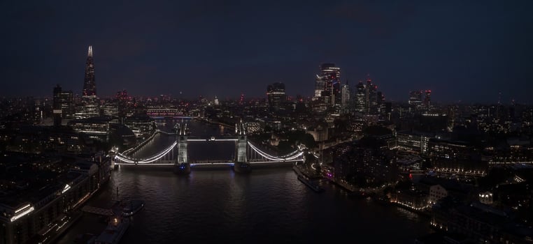 Aerial view to the illuminated Tower Bridge and skyline of London, UK photo