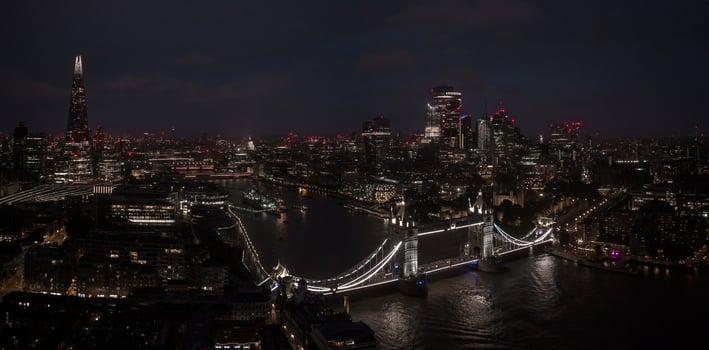 Aerial view to the illuminated Tower Bridge and skyline of London, UK photo