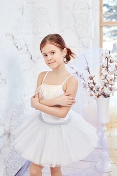 Young ballerina girl is preparing for a ballet performance. Little prima ballet photo