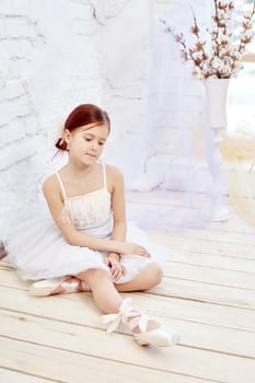 Little prima ballet. Young ballerina girl is preparing for a ballet performance photo