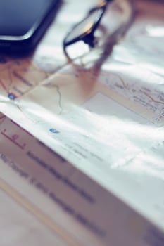 Map, map of Washington state, pen, glasses, cell phone, coffee cup on the table. photo