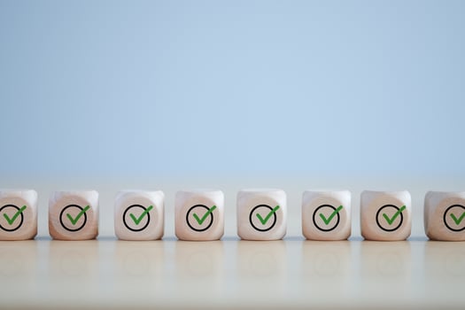 Checklist, Task list, Survey and assessment. Quality Control. Goals achievement and business success. Green check mark icon on wooden blocks. photo