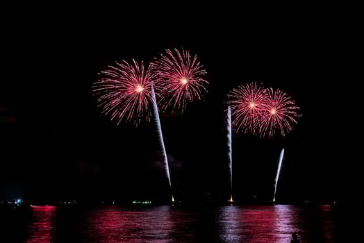 fireworks celebration over sea in pattaya beach photo