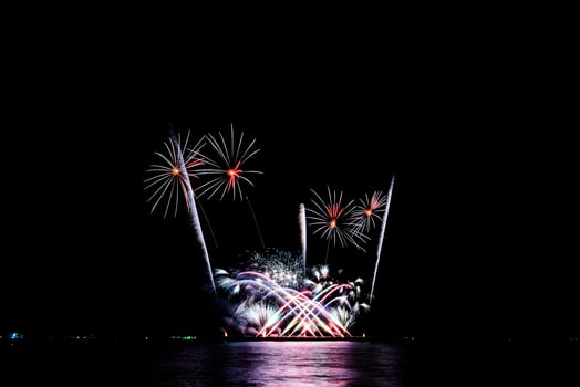 fireworks celebration over sea on pattaya beach photo