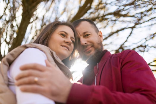 portrait of an adult traditional married couple with touching foreheads against the background of an autumn tree photo