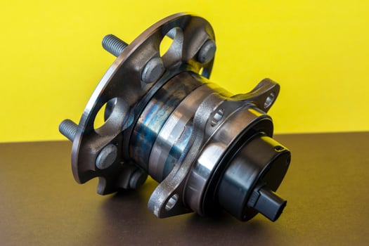 Rear wheel hub assembly with ABS sensor on a colored background, auto parts, bearing photo