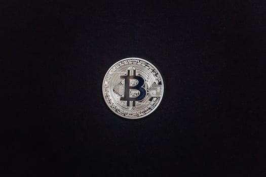 Cryptocurrency silver bitcoin coin on black background. Electronic virtual money for web banking and international network payment. Symbol of crypto virtual currency. Mining concept. photo