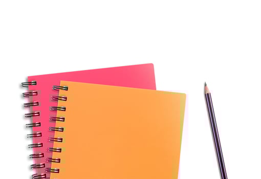 colored notebook and pencils isolated on white background photo