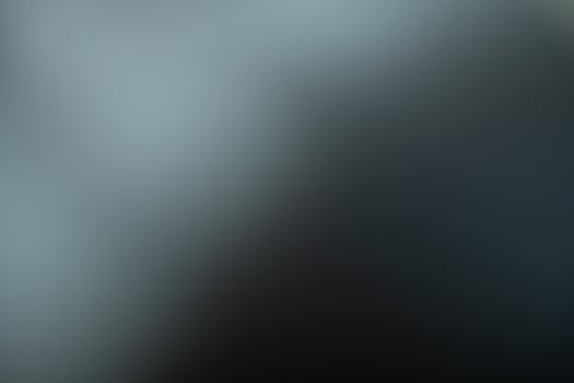 Dark black and gray blurred  gradient background has a little abstract light. photo