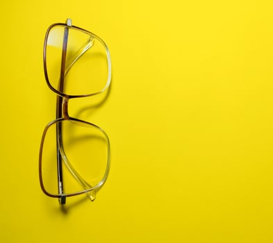 clear glasses on a yellow background  copy space photo