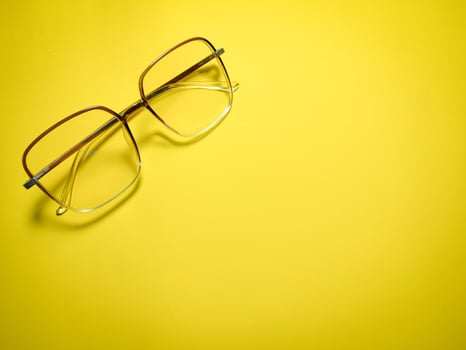 clear glasses on a yellow background  copy space photo