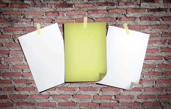 White paper and old paper. Stick tape on the gray brick wall photo