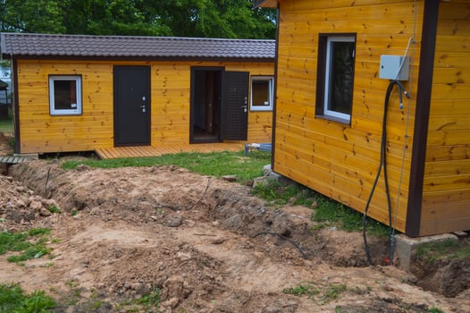 Construction of small yellow wooden frame prefabricated pre-fabricated eco-house of suburban modular fast-growing houses, buildings, cottages. Industrial builde photo